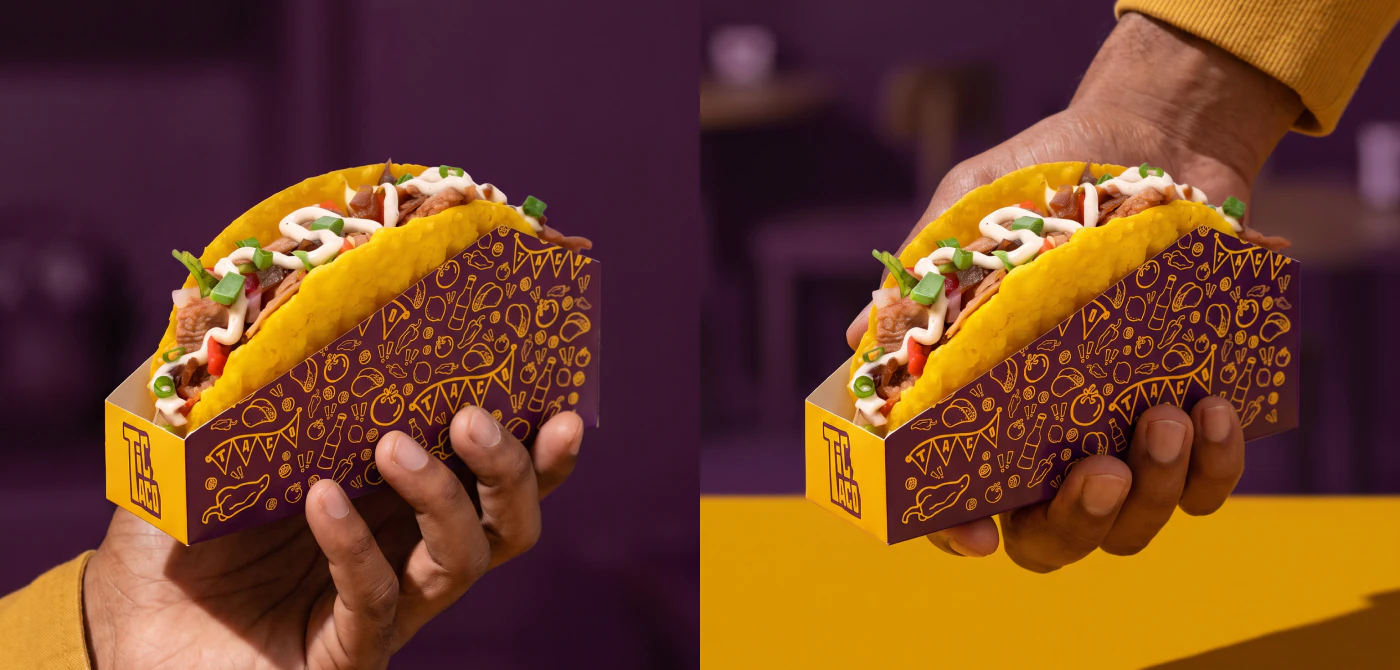 Tacos in their holders, held in hand